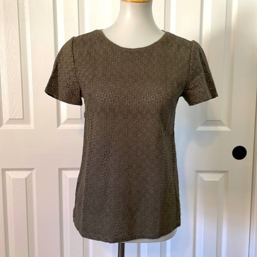 Ann Taylor short sleeve army green shirt with flower cut out design on front.